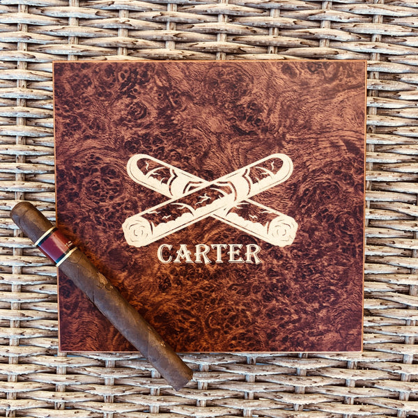 Burl wood cigar humidor engraved with the name Carter and a crossed cigars emblem, a compact personalized mini humidor for a first collection or desk