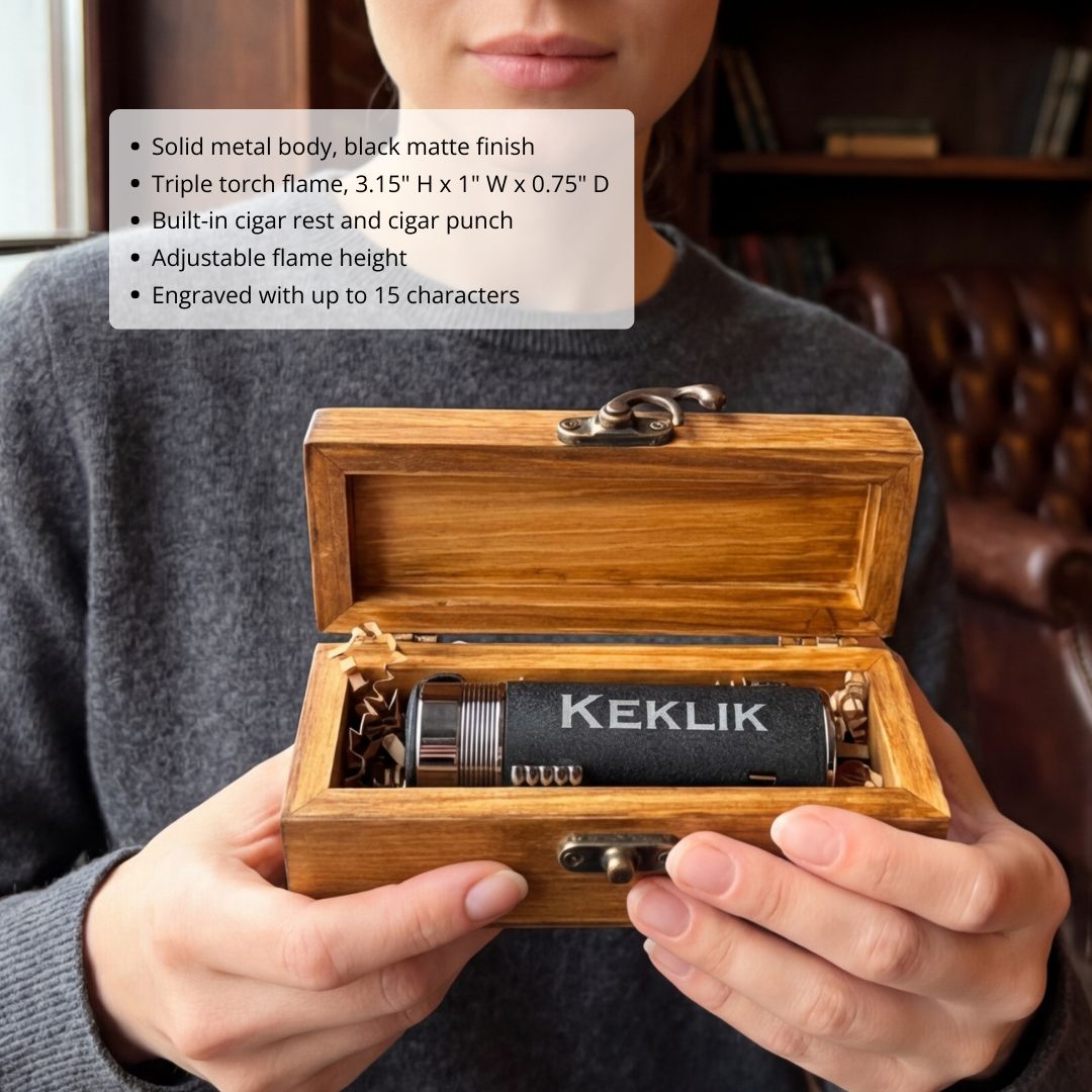 Black matte triple-torch lighter with built-in cigar rest and punch, engraved with sample name "KEKLIK", displayed in wooden presentation box